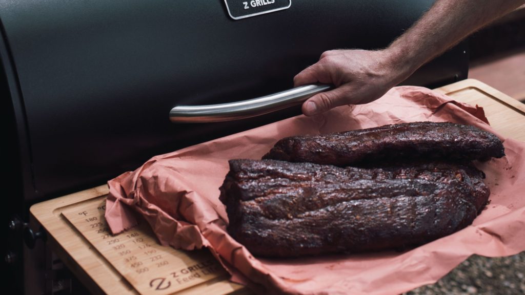 Grill with Brisket on Butcher Paper and Chopping Board