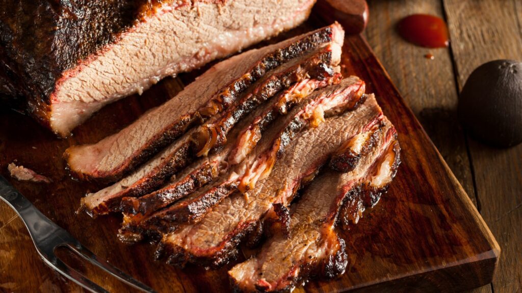 Juicy and Perfectly Sliced Smoked Brisket on a Chopping Board